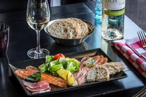 a table with a plate of food and a glass of wine at Pointe Isabelle in Chamonix-Mont-Blanc