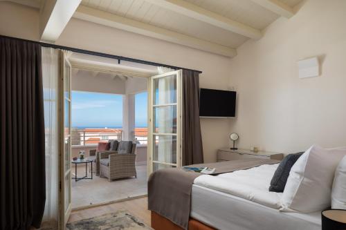 a hotel room with a bed and a balcony at Villa Estelle by ILC (Istria Luxury Collection) in Brtonigla