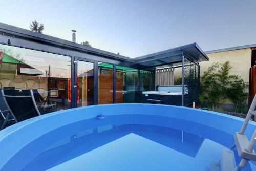 a swimming pool in front of a house at Anita in Budapest