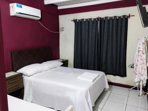 a hotel room with two beds and a tv at Tu hogar en las cataratas in Puerto Iguazú