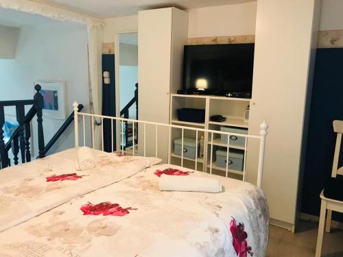 a bedroom with a bed with red flowers on it at Chrysa's Holiday Apartment in Pylos