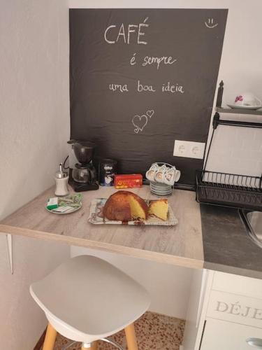 a table with a loaf of bread and a sign at Apartment with pool in the mountains. in Alicante