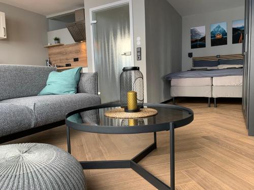 a living room with a couch and a table at Ebbe&Flut in Bremerhaven