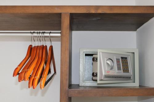 a bunch of carrots on a shelf next to a microwave at Hotel 52 Playa del Carmen in Playa del Carmen