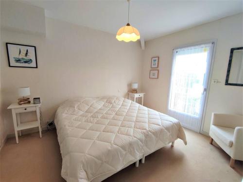 a white bedroom with a bed and a window at Bel Appartement 3* au Centre de Perros-Guirec avec WIFI, Balcon et Parking - FR-1-368-337 in Perros-Guirec