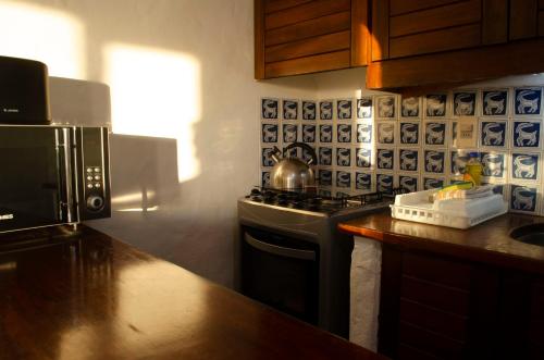 a kitchen with a stove top oven next to a counter at Club Hotel Casapueblo in Punta del Este