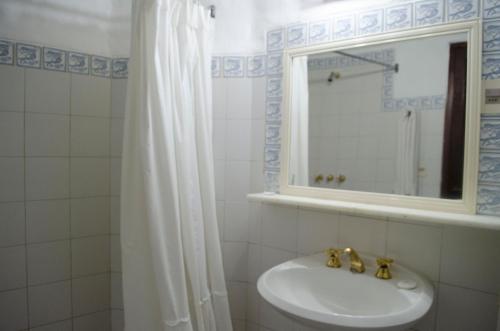 a bathroom with a sink and a mirror at Club Hotel Casapueblo in Punta del Este