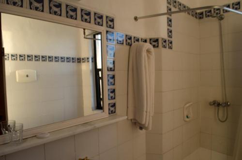 a bathroom with a shower and a mirror at Club Hotel Casapueblo in Punta del Este