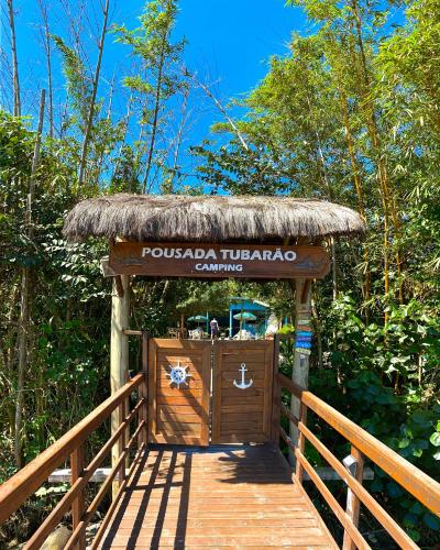 a wooden gate with a sign for a resort at Pousada & Camping Tubarão in Ilha do Mel