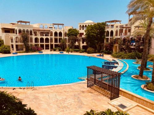 a large swimming pool in front of a building at Tala bay apartments 2 bedroom in Aqaba