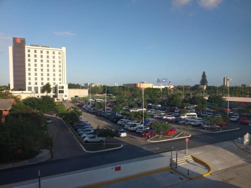 a parking lot with cars parked in a parking lot at Extended Suites Merida Siglo XXI in Mérida