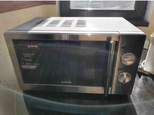a toaster oven sitting on top of a microwave at Vila Sunset in Galaţi
