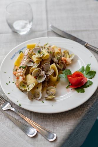 a plate of food with shrimp and mushrooms on a table at Hotel Continental in Tortoreto Lido