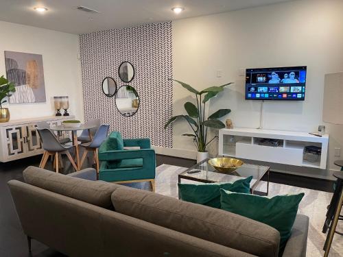 a living room with a couch and a table at Modern Downtown Houston Your Home Base for City Adventures! in Houston