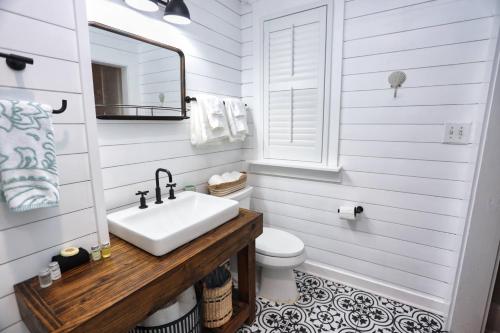a white bathroom with a sink and a toilet at Historic Home Family Friendly Close to Seawall in Galveston