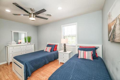 a bedroom with two beds and a ceiling fan at 413 Camway Drive in Wilmington