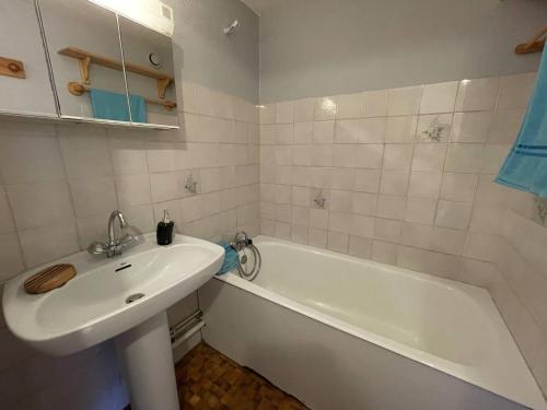 a bathroom with a sink and a tub and a white sink at Appartement Vallouise-La Casse, 2 pièces, 5 personnes - FR-1-330G-34 in Le Poët