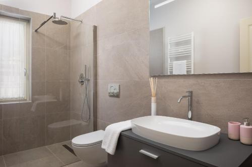 a bathroom with a sink and a toilet and a shower at Villa Florence by ILC-Istria Luxury Collection in Brtonigla