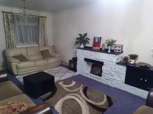 a living room with a couch and a fireplace at 21 Orion drive in Bristol