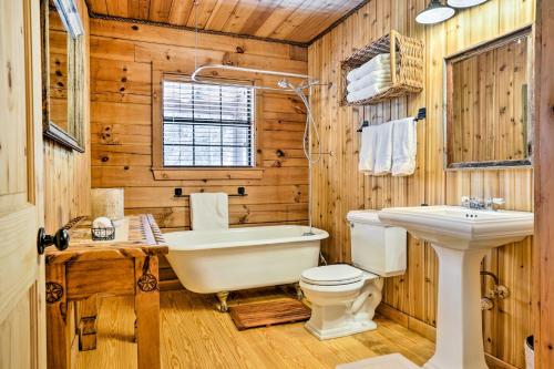 a bathroom with a toilet and a tub and a sink at Cozy New Braunfels Family Cabin with Porch and Views! in New Braunfels