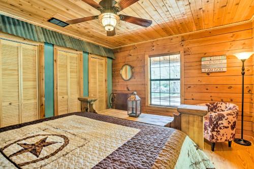 a bedroom with a bed and a ceiling fan at Cozy New Braunfels Family Cabin with Porch and Views! in New Braunfels