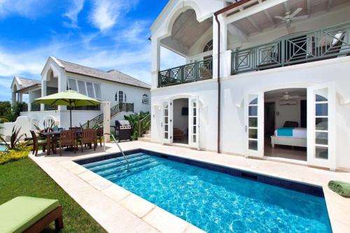 an exterior view of a house with a swimming pool at Royal Westmoreland - Sugar Cane Ridge by Blue Sky Luxury in Saint James