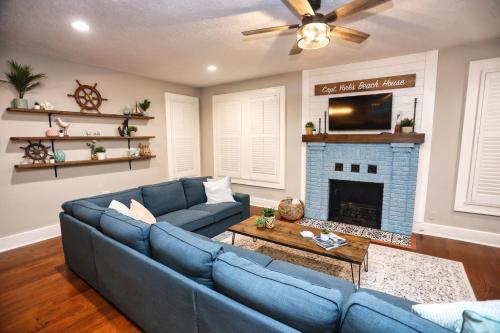 a living room with a blue couch and a fireplace at Historic Home Family Friendly Close to Seawall in Galveston