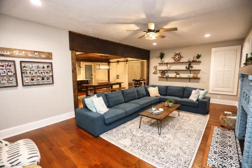a living room with a blue couch and a table at Historic Home Family Friendly Close to Seawall in Galveston