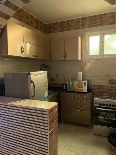 a kitchen with stainless steel appliances and a counter at Sunrise shiny Nubian Guest House in Aswan