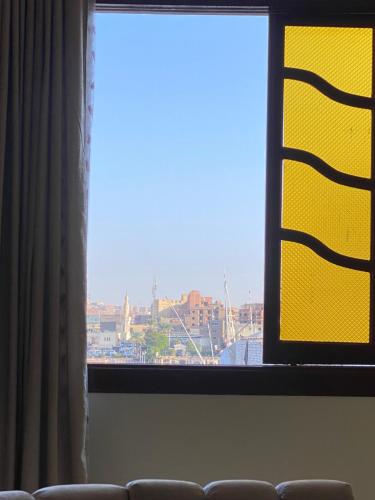 a large window with a view of a city at Sunrise shiny Nubian Guest House in Aswan