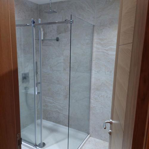 a shower with a glass door in a bathroom at Apartman Ana Alibi 1 in Zlatibor