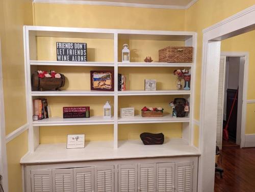 a book shelf in a living room with signs on it at Fully Restored Country Manor in Baldwin