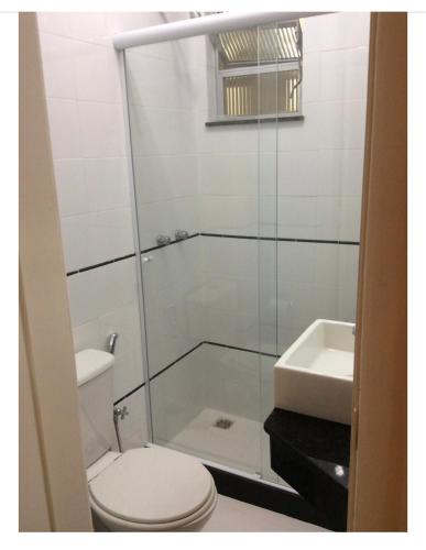 a bathroom with a toilet and a sink at Lindo Studio Ipanema in Rio de Janeiro