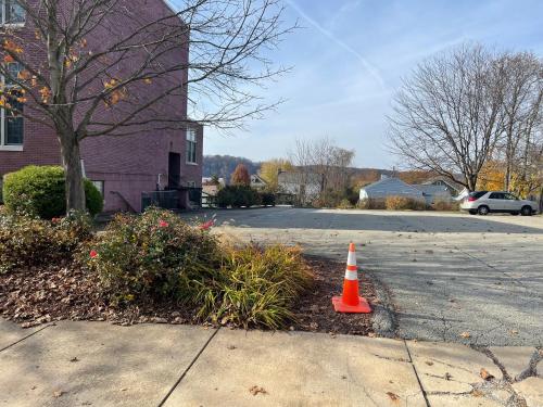 a orange cone sitting in the middle of a street at Pershing Heights 200 in New Kensington