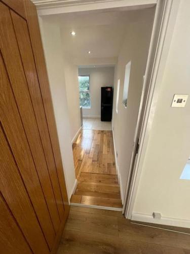 un pasillo de una casa con puerta de madera en Green lanes N8, Studio flat! en Londres