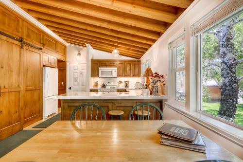 a kitchen with wooden cabinets and a table with chairs at Single Level Ranch Condo in Elkhorn in Sun Valley