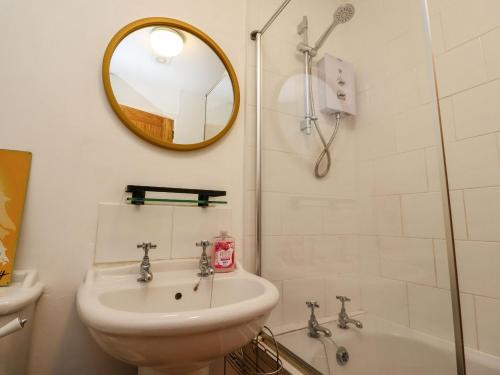 a bathroom with a sink and a toilet and a mirror at 3 South View in Horton in Ribblesdale