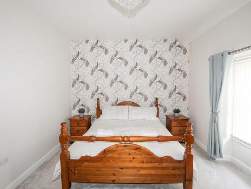 a bedroom with a bed and a wall with fish on it at 6 Erasmus Street in Penmaen-mawr