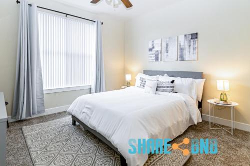 a bedroom with a large white bed and a window at Charming Dallas Getaway W Modern Amenities in Dallas