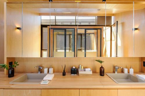 a bathroom with two sinks and a mirror at Casa Wynwood Roma Norte in Mexico City