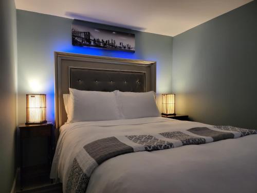 a bedroom with a large bed with a blue light at Comfy and Chic Boston Apartment! in Boston