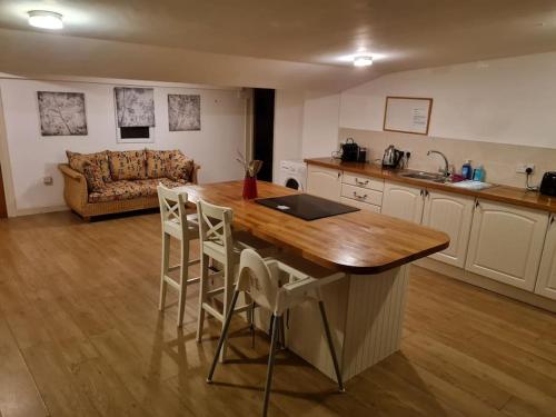 a kitchen with a table and chairs and a couch at The Hillock in Uplawmoor