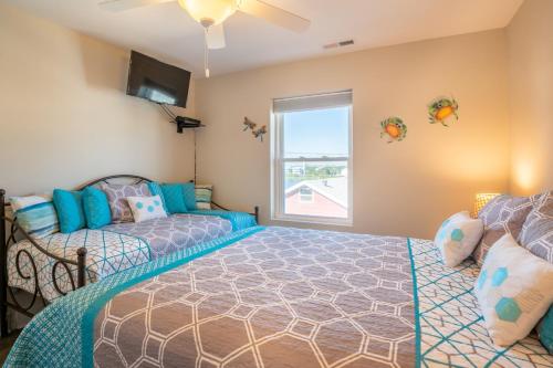 a bedroom with two beds and a window at Sands IV 2-G in Carolina Beach