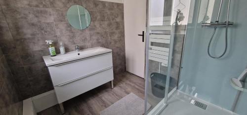 a bathroom with a sink and a shower at L'air du large in Le Tréport