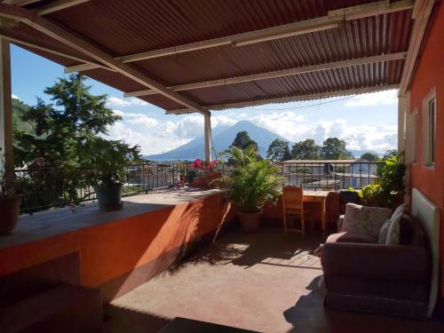 a patio with a table and chairs and a view at Casa de Alondras in Panajachel