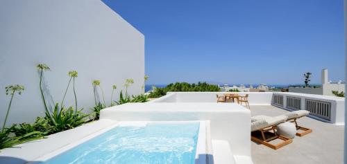 a swimming pool on the roof of a house at Oia Treasures Art Suites in Oia
