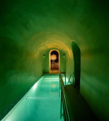 a swimming pool in a tunnel with a ceiling at Oia Treasures Art Suites in Oia