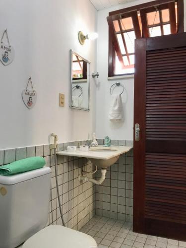 a bathroom with a toilet and a sink at Casa com piscina no Maçarico - Casa Água Viva in Salinópolis
