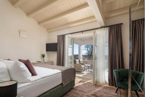 a hotel room with a bed and a balcony at Villa Iris by ILC (Istria Luxury Collection) in Brtonigla