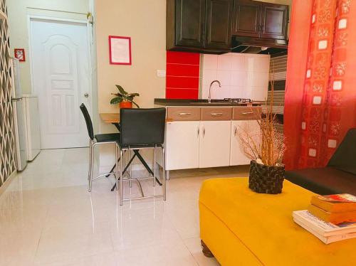 a kitchen and a living room with a table and chairs at Calido Y Confortable in Santo Domingo
